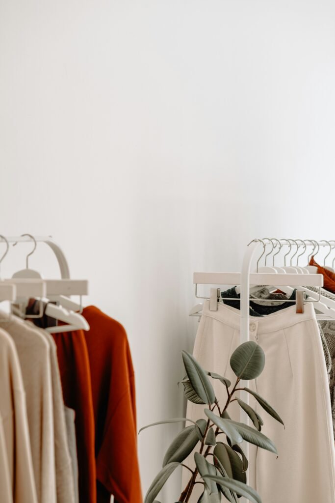 Clothing rack with neutral toned garments, a capsule wardrobe of essentials