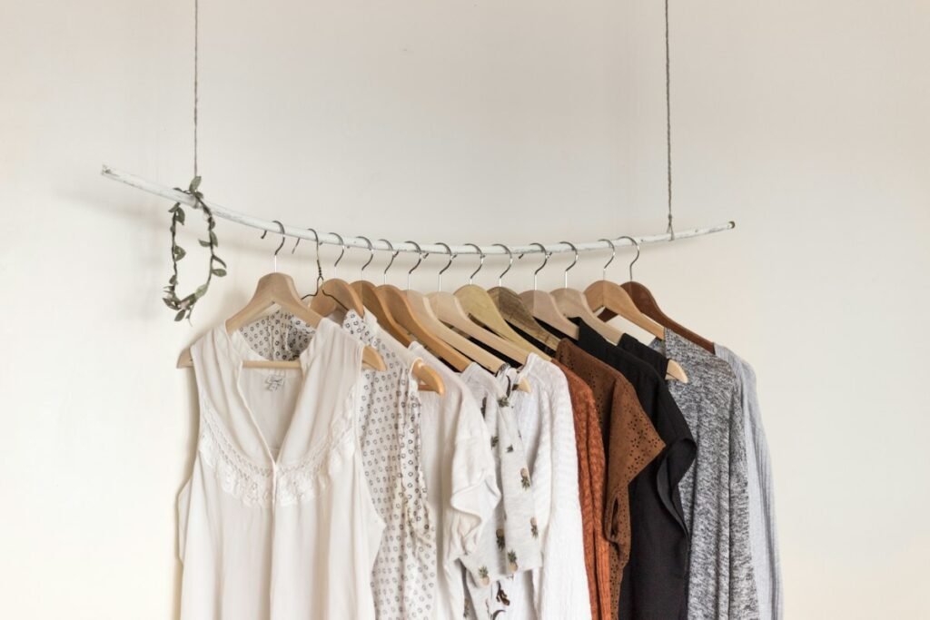 Woman choosing clothes on a rack to dress stylishly on a budget